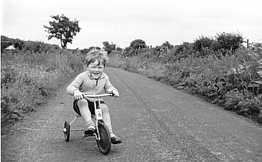Peter Gregor aged 3,cycling on the wrong side of the road